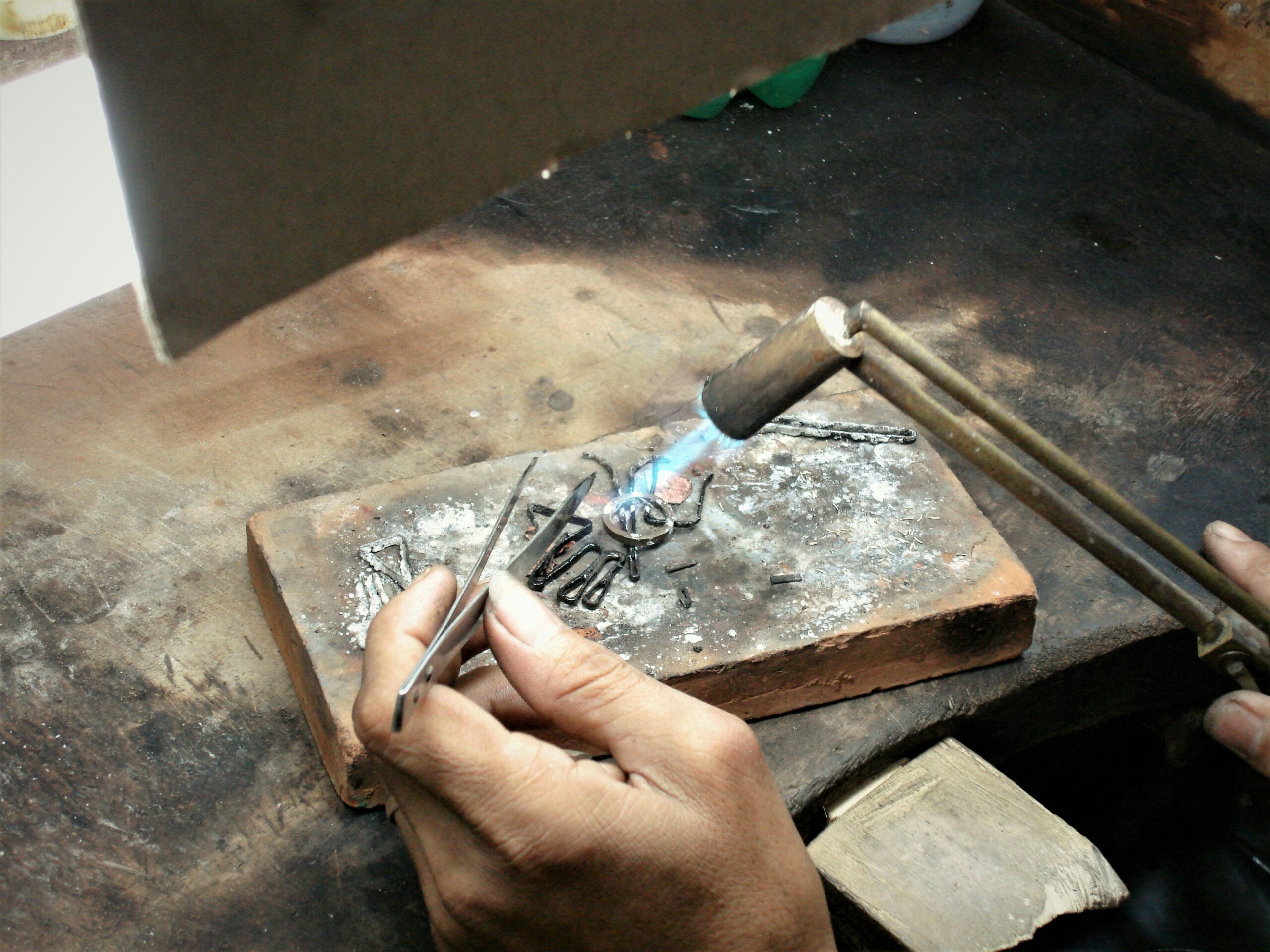 Third hand tweezers holding jewelry components for soldering