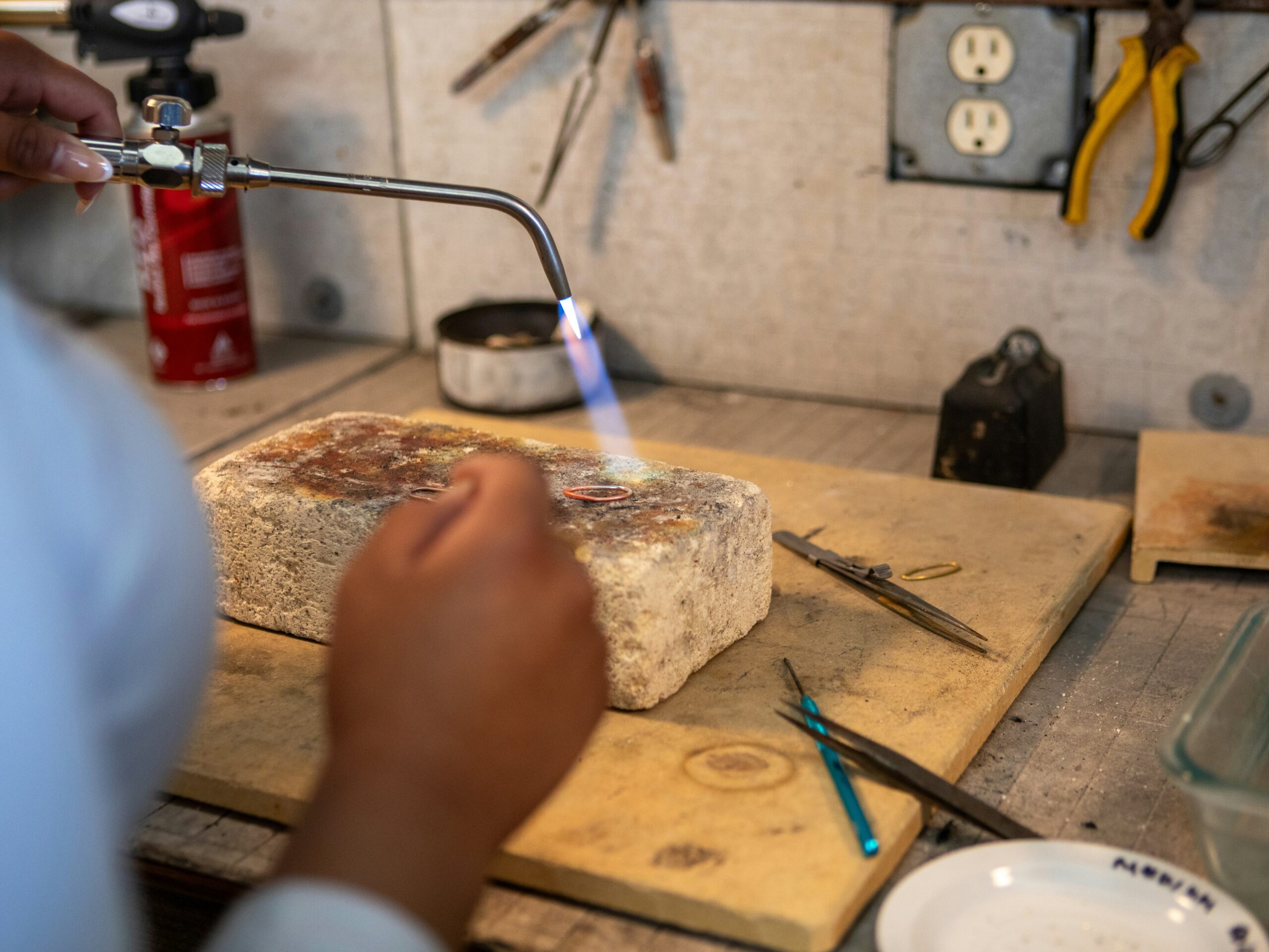 Silver jewelry soldering flame and heat exposure on workbench