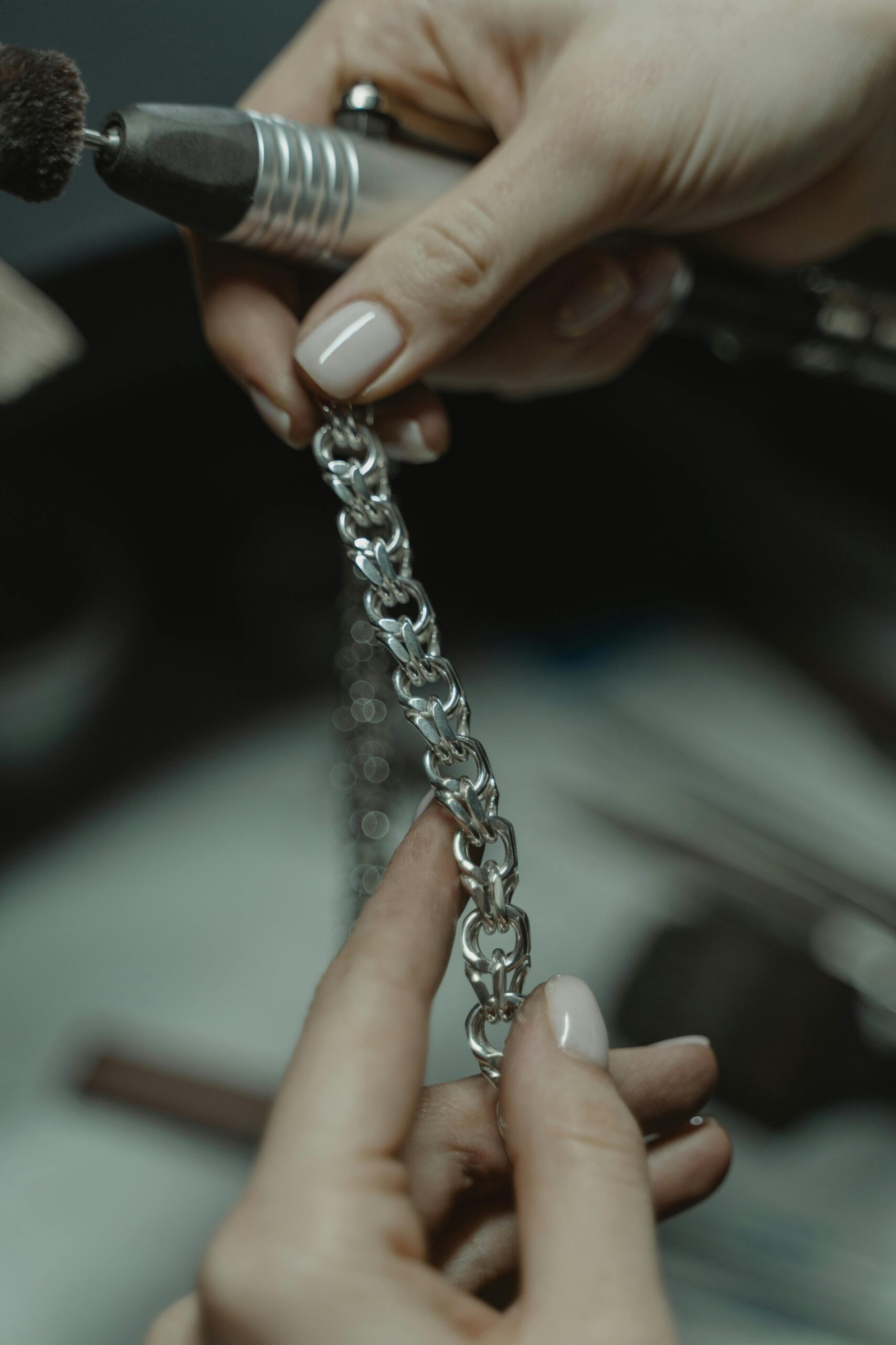 Jewelry maker using controlled filing and surface refinement on a silver component