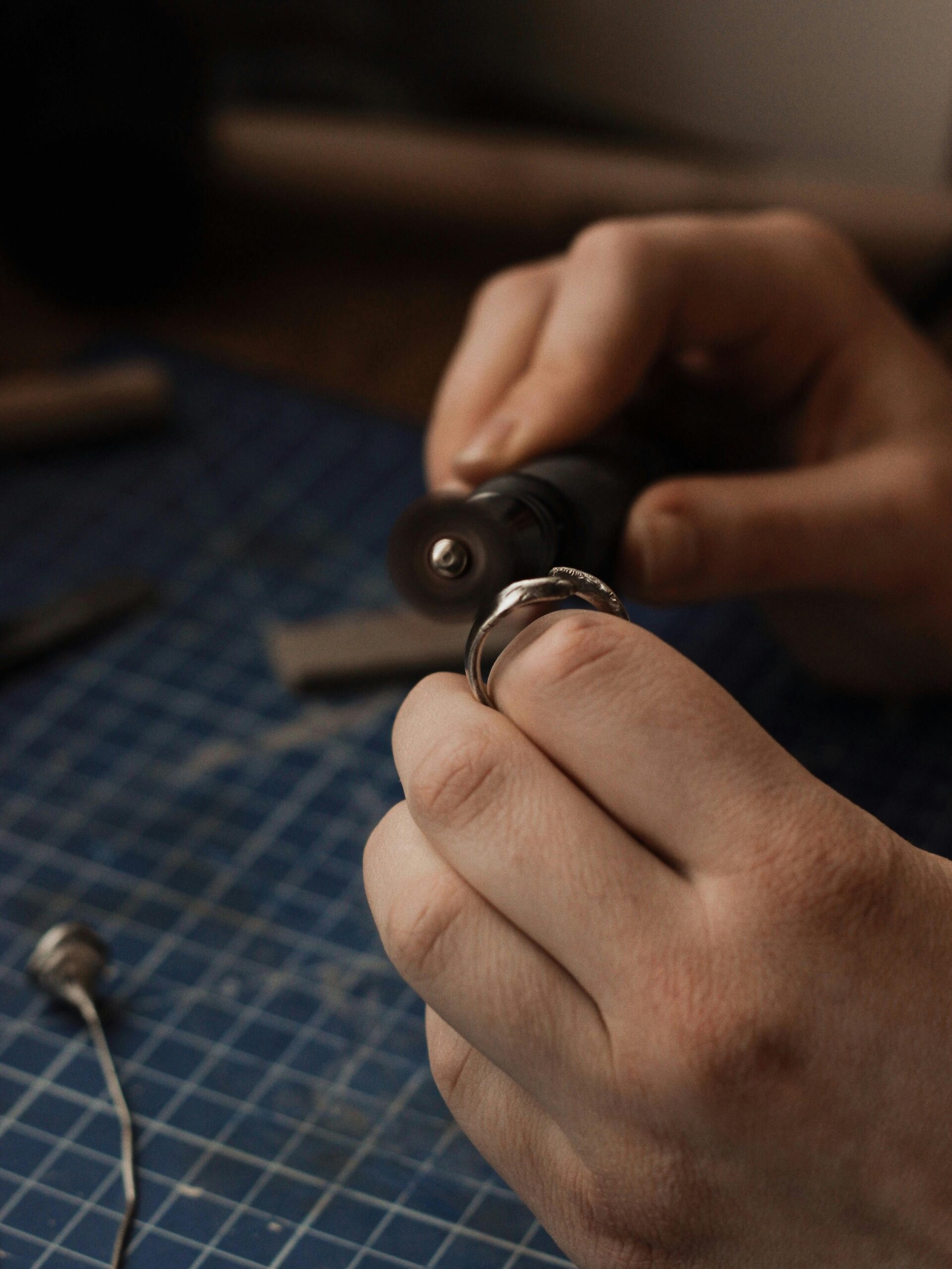 Jewelry maker adjusting a ring component by hand during fabrication