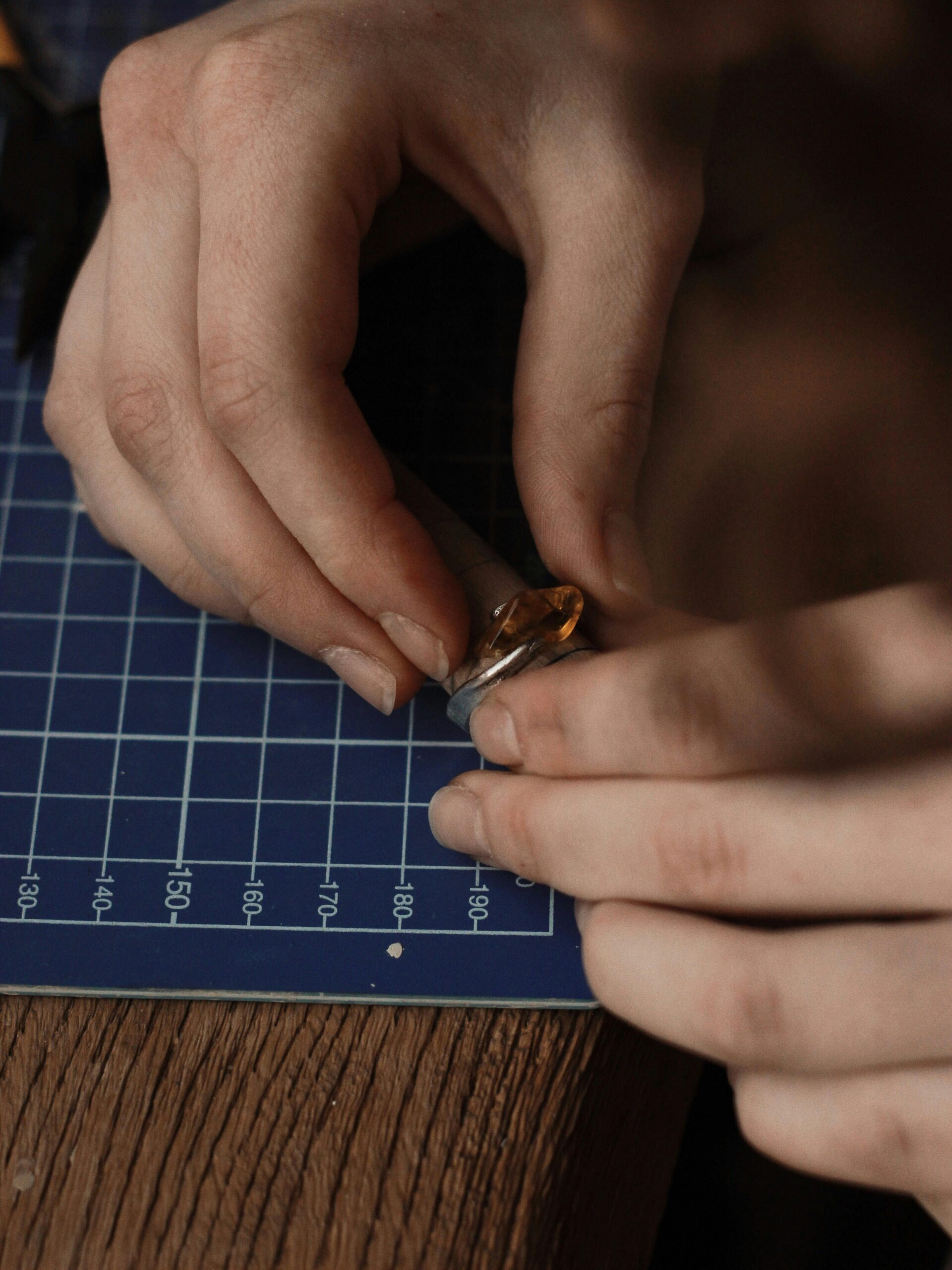 Jewelry maker preparing a ring component at the bench for width and blank planning
