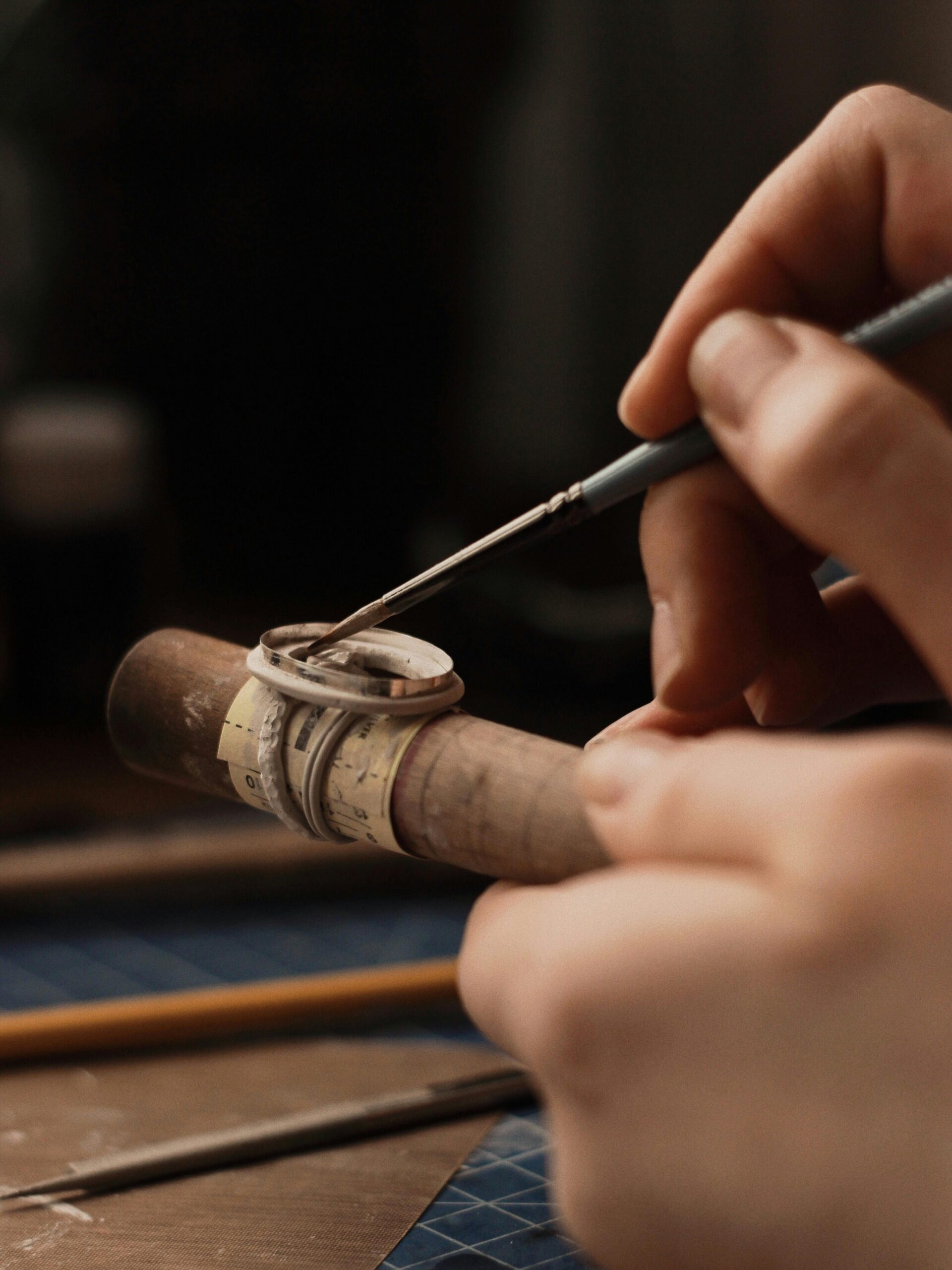 Jewelry maker checking a ring component during handmade ring fabrication