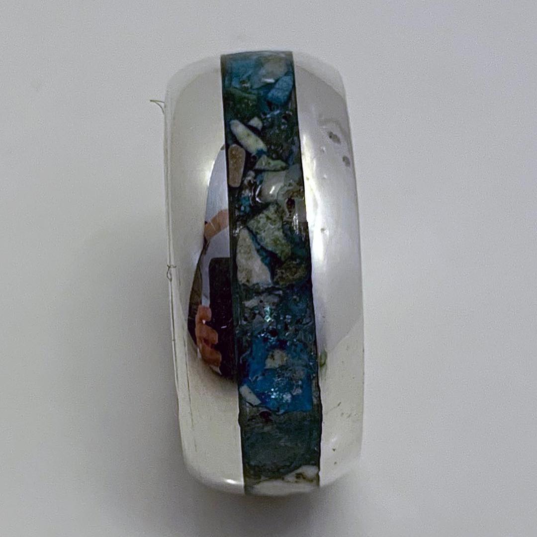Jewelry maker forming a ring component carefully during fabrication