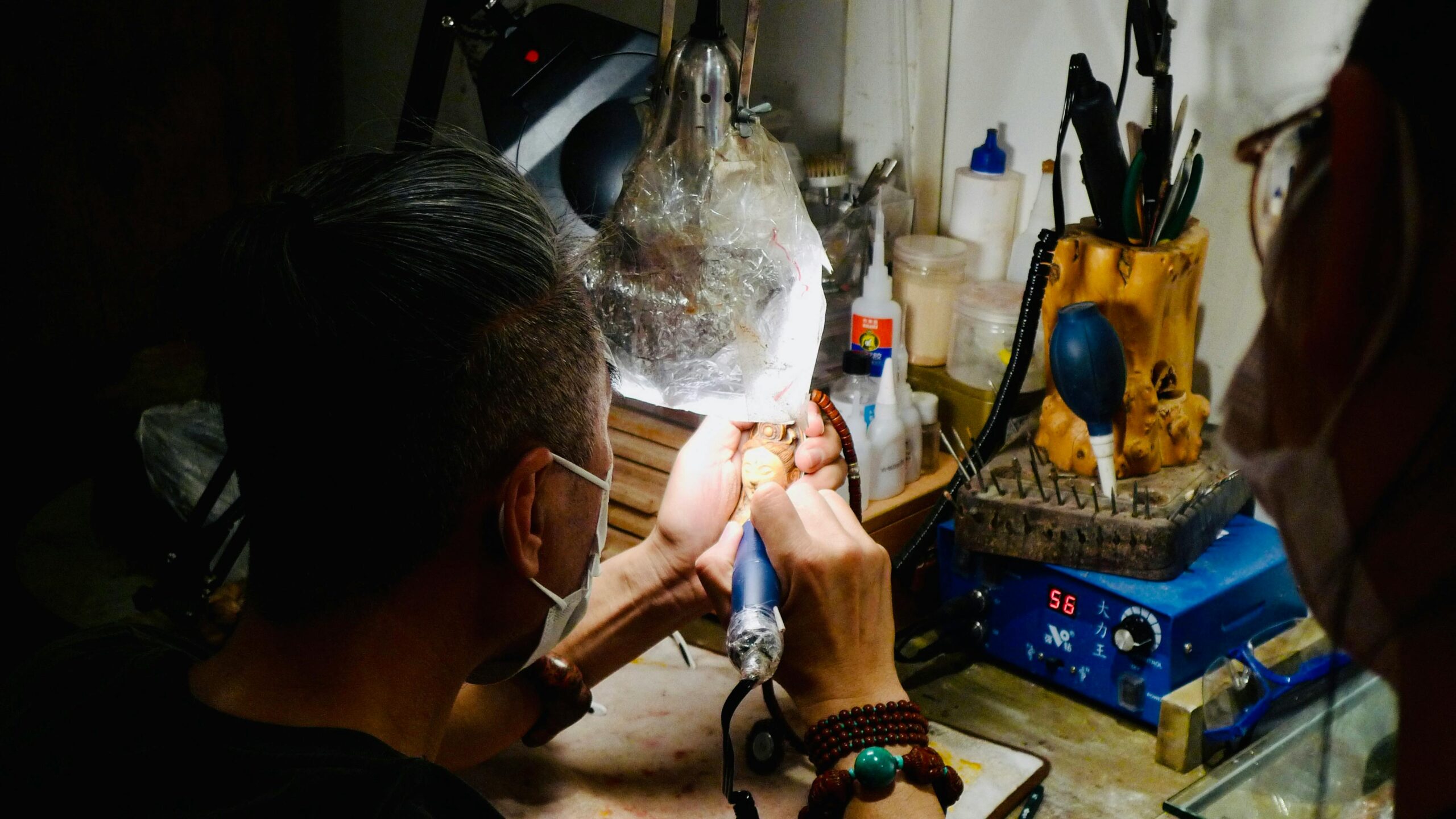 Jewelry torch flame heating silver during soldering or heat-control work