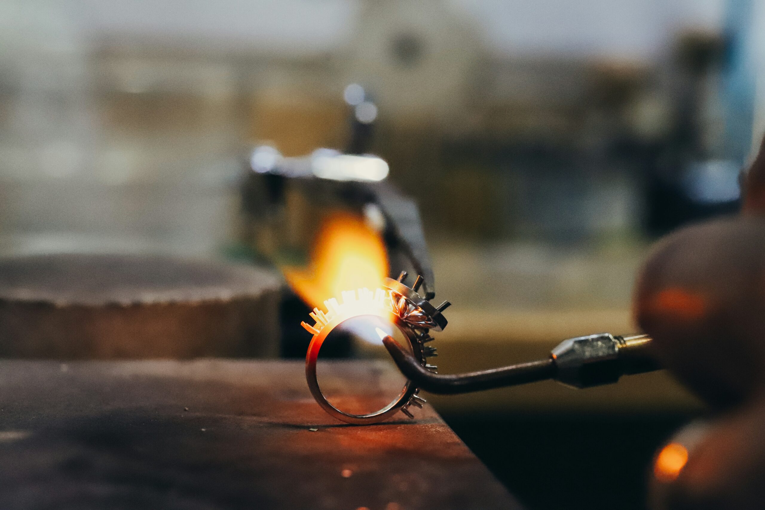 Ring being heated by a torch flame during silver soldering